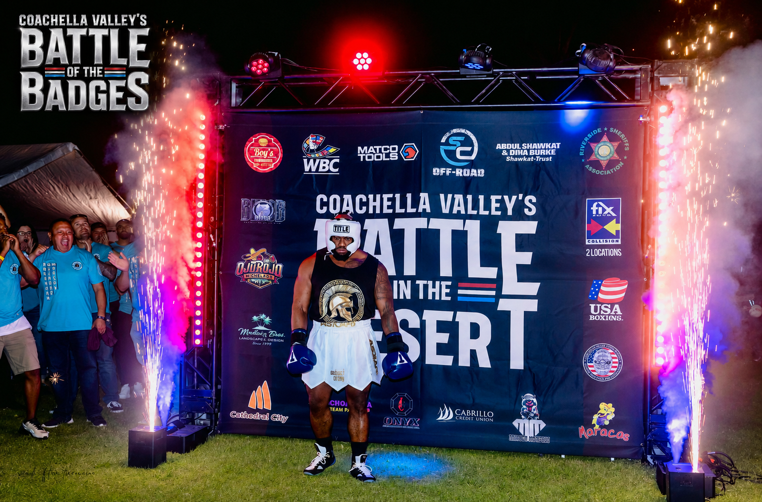 Fighter walking out with red and blue sparks at Battle of the Badges