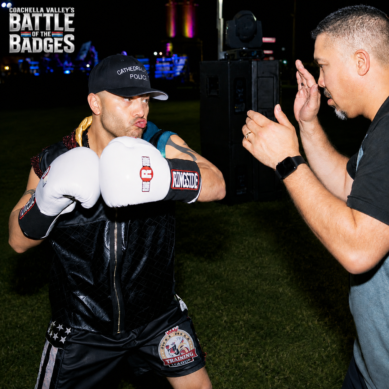 Cathedral City police officer working mitts with a coach at Battle of the Badges