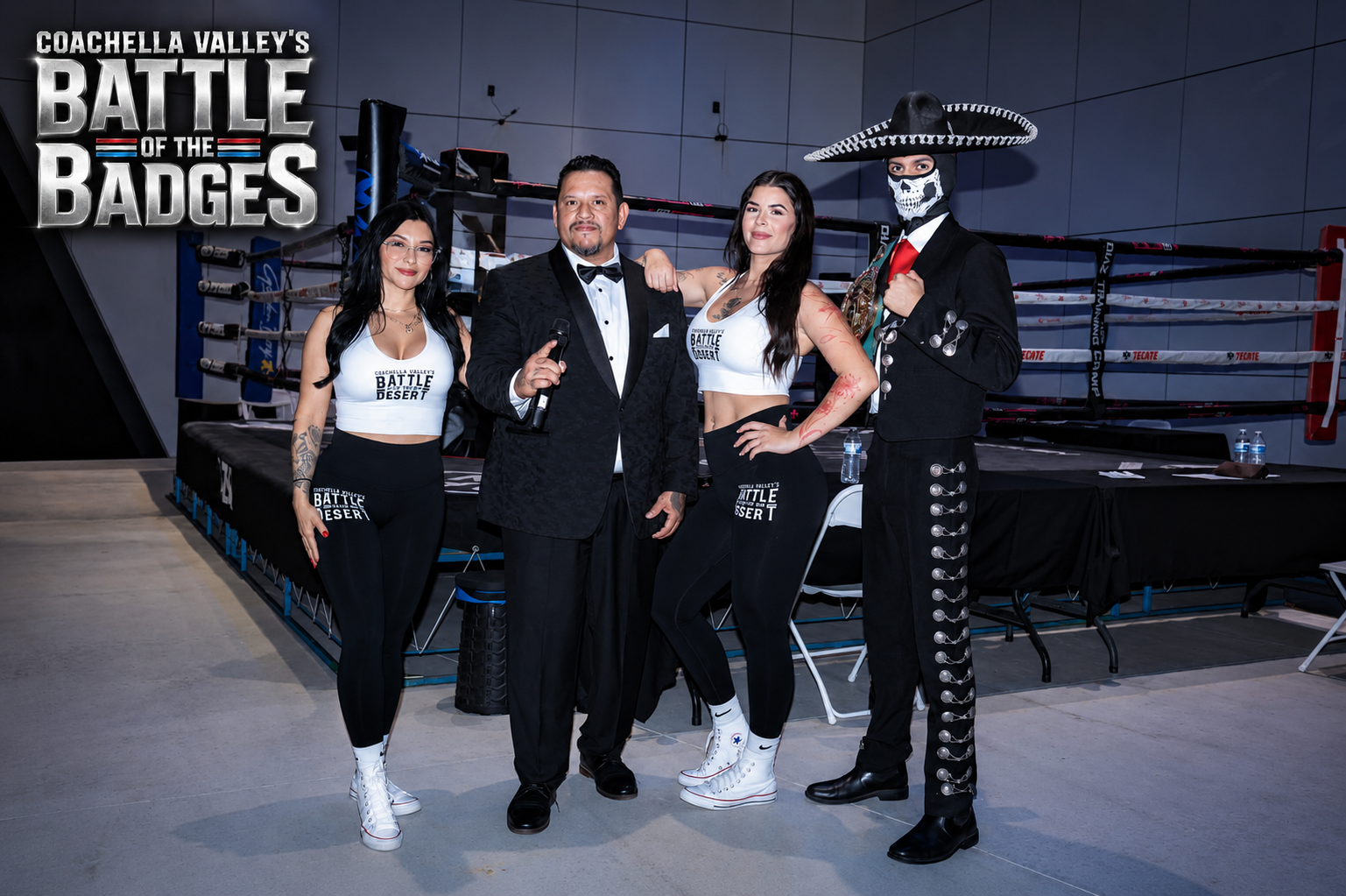 Battle of the Badges announcer, ring card team, and masked champion posing near the ring