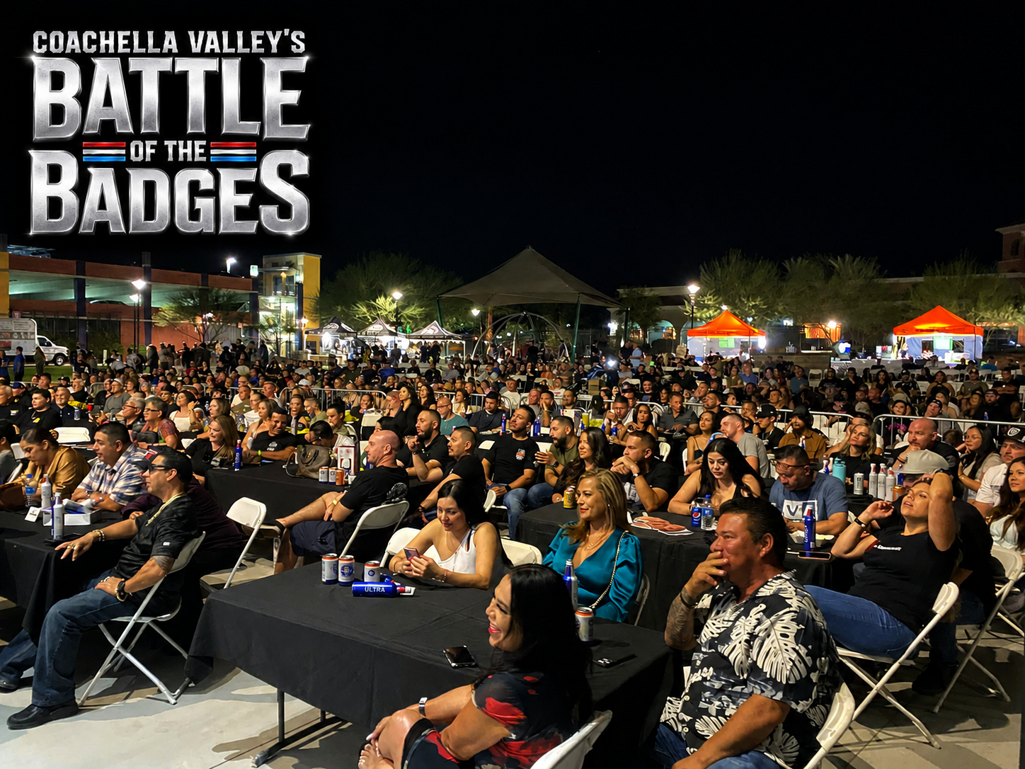 Packed crowd seated at tables watching Battle of the Badges fight night